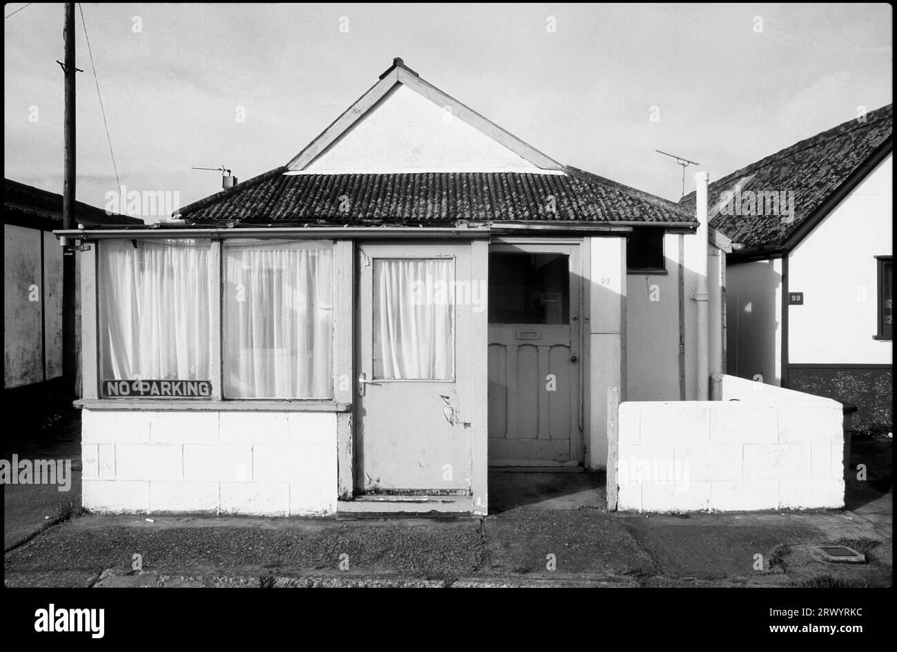 Chalets at Shelly Beach, Exmouth, Devon, England, UK. Greyscale image from colour transparency Stock Photo