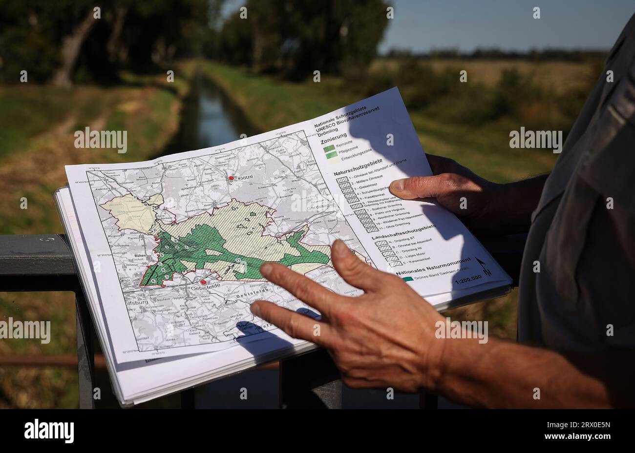 Germany. 15th Sep, 2023. Fred Braumann, head of the Unesco biosphere reserve Drömling, holds a map showing the different zones of the Drömling. Rewetting of the moor, three-quarters of which is in Saxony-Anhalt and one-quarter in Lower Saxony, began about 15 years ago. The area is crisscrossed by a canal system that measures 2200 kilometers in length. Credit: Ronny Hartmann/dpa/Alamy Live News Stock Photo