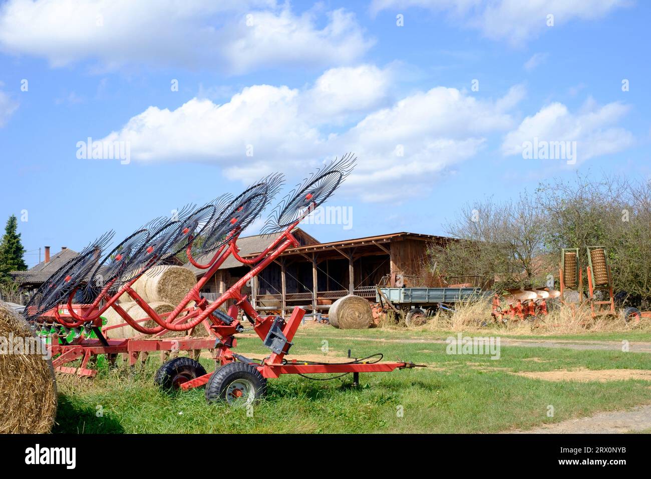 farming agricultural implement tractor towed trailer wheel rake Stock Photo