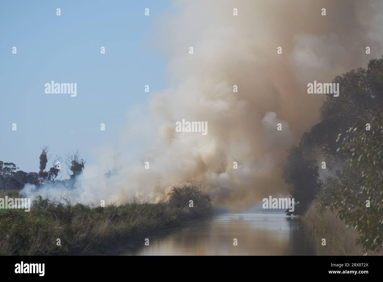 Girgarre Victoria Australia, 22nd Sept 2023, Heavy grey smoke from burning off dry grasses in favourable conditions before the green grass dries out. Creating a fire break before bush fire season on rural property. Stock Photo