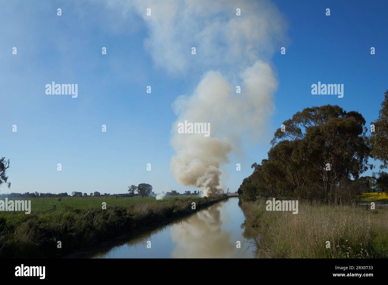 Girgarre Victoria Australia, 22nd Sept 2023, Heavy grey smoke from burning off dry grasses in favourable conditions before the green grass dries out. Creating a fire break before bush fire season on rural property. Stock Photo