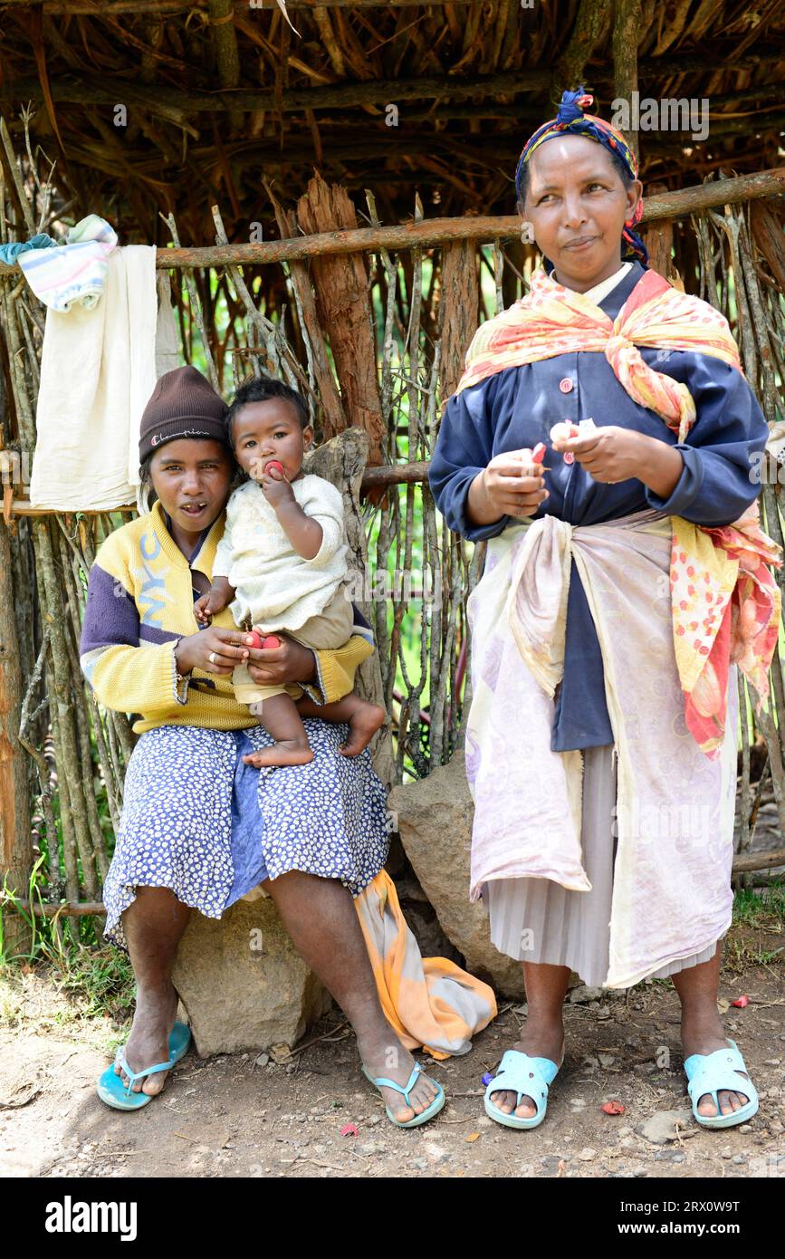 Malagasy women sitting by the road in central Madagascar. Stock Photo