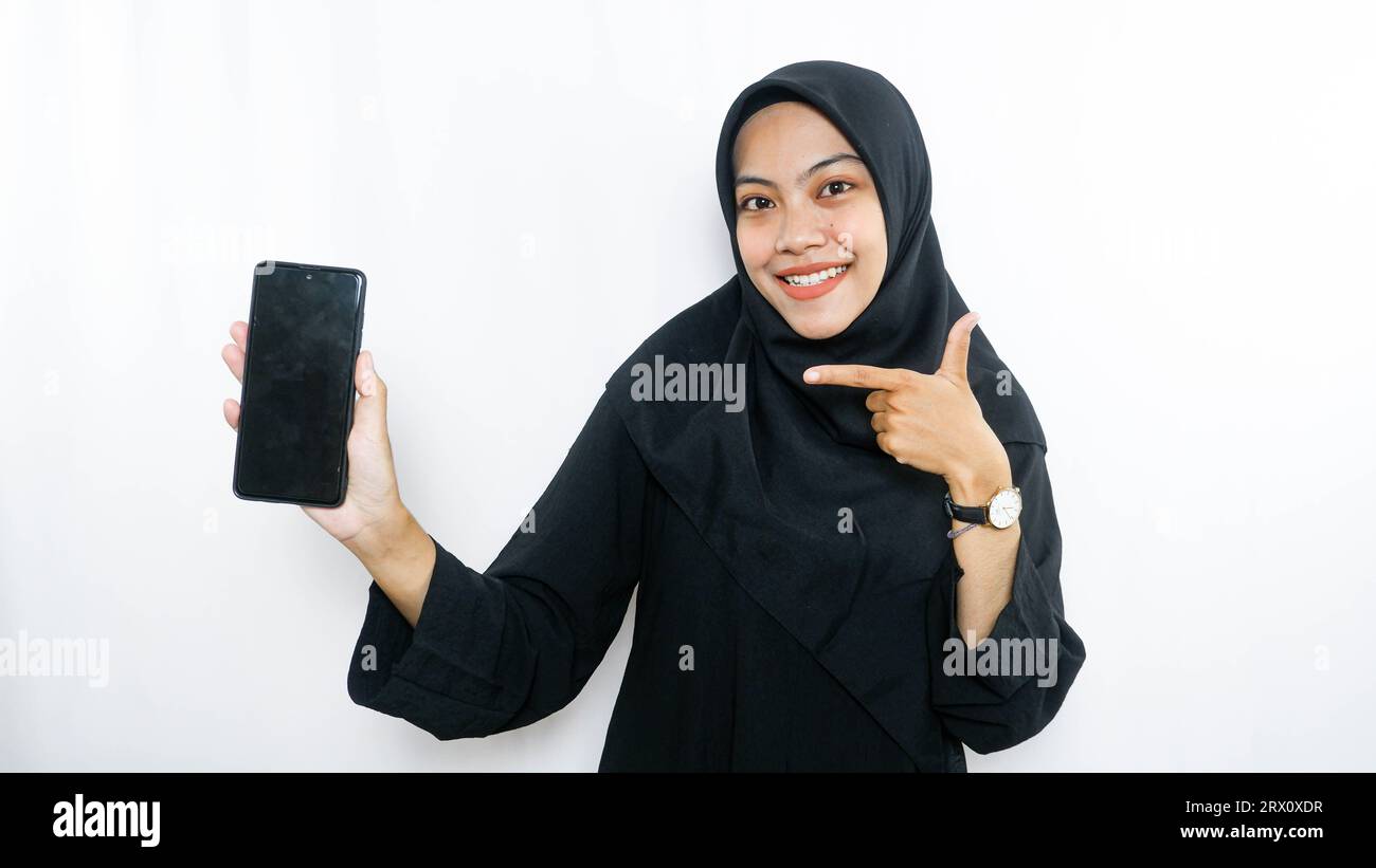 Cheerful young Asian woman taking selfie, look smartphone front camera isolated over white background Stock Photo