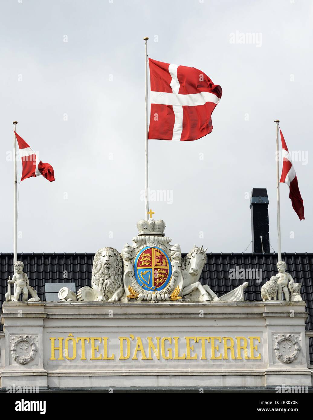 The Danish flag on top Hotel D'Angleterre by the Kings New Square in central Copenhagen, Denmark. Stock Photo