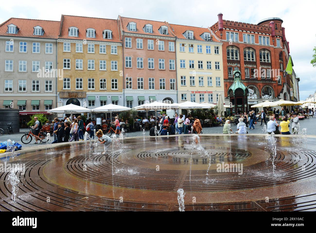 Children playing in the fountain at the Kultorvet square in Copenhagen, Denmark. Stock Photo