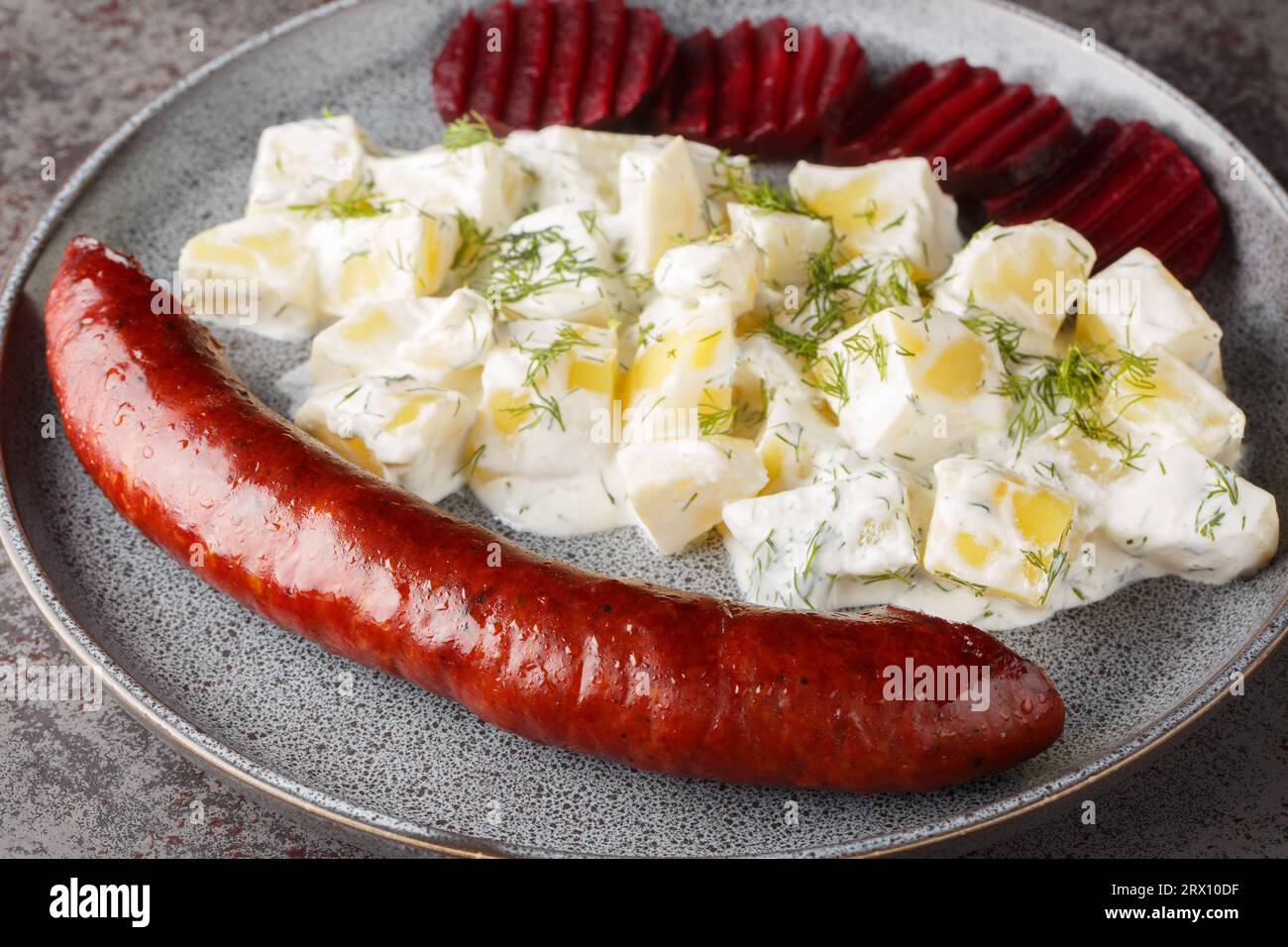 https://c8.alamy.com/comp/2RX10DF/swedish-lard-sausage-isterband-with-potatoes-in-cream-sauce-with-dill-and-boiled-beets-close-up-on-a-plate-on-the-table-horizontal-2RX10DF.jpg