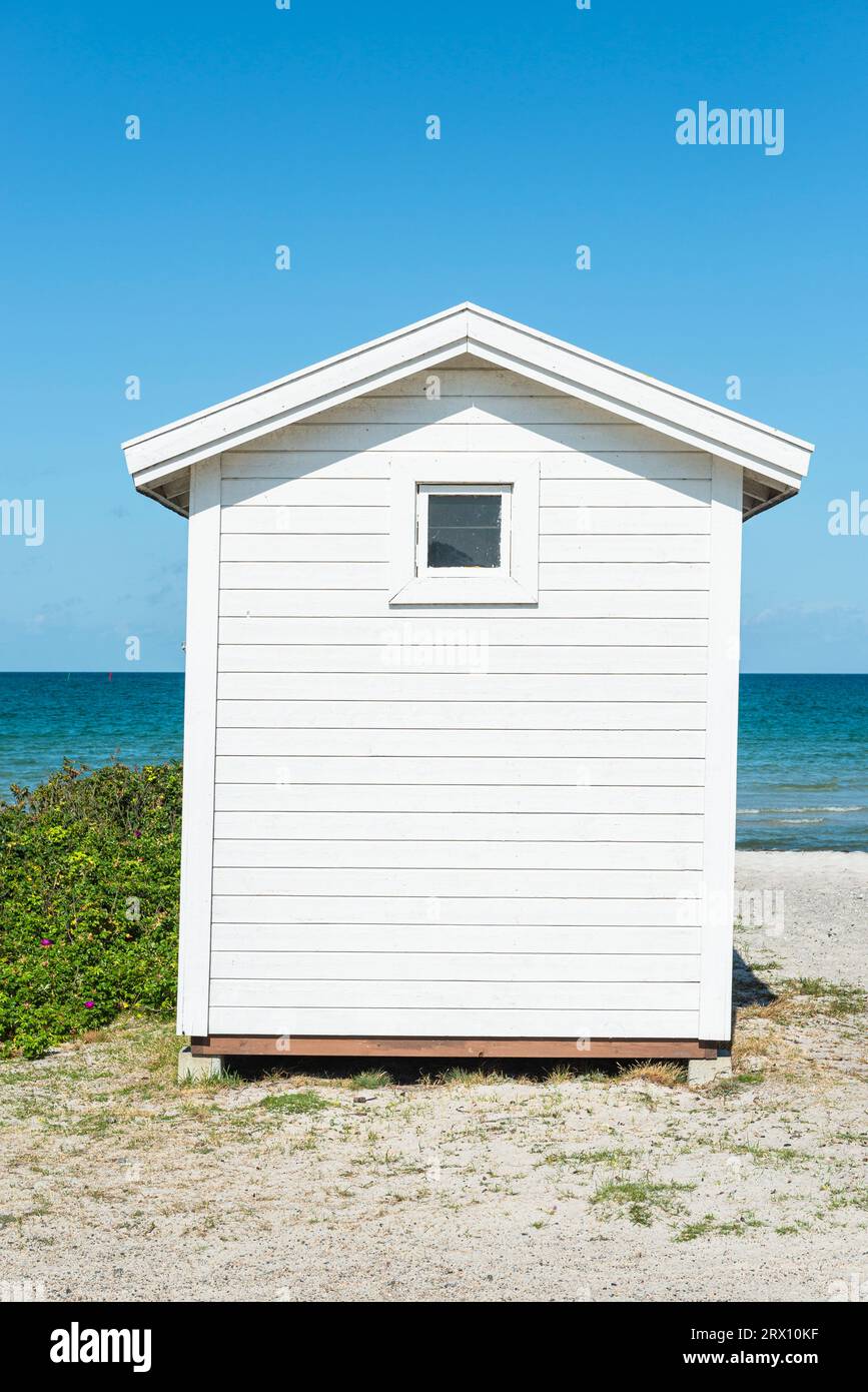 Frontal view of the back of a white wooden bathing hut on the beach of Skanör med Falsterbo at the Öresund in the morning sun, Skåne, Sweden Stock Photo