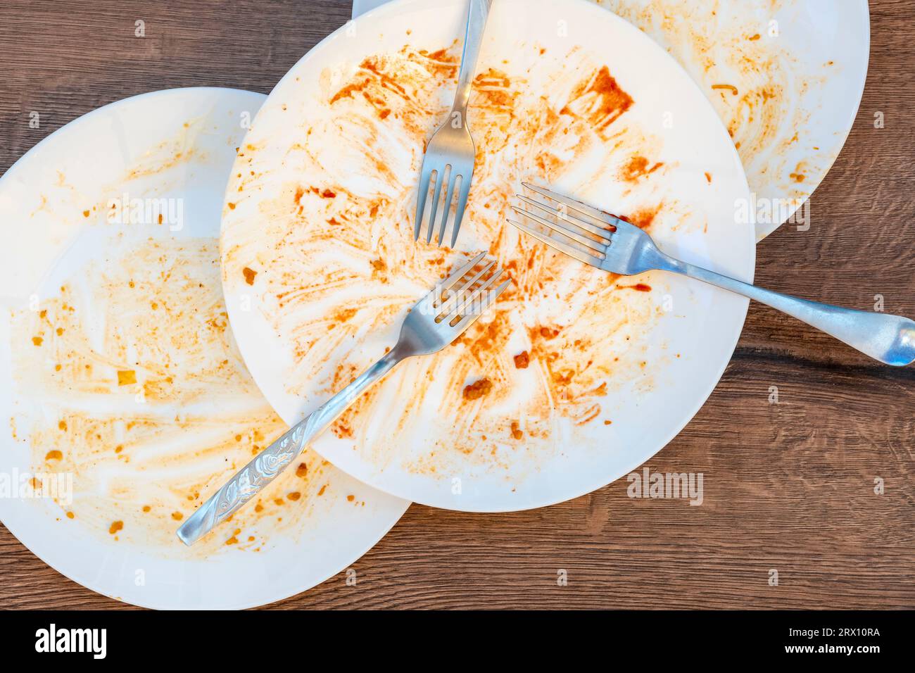 dirty plates, forks, cutlery after eating. Dirty dishes after eating. End of meal. Good appetite, delicious food and dish concept. top view Stock Photo