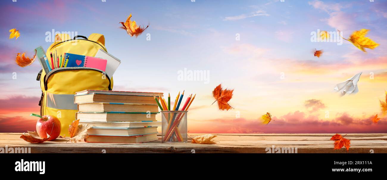 Back To School - Schoolbag And Books With Pencils And Stationary On Autumn Table With Leaves Stock Photo