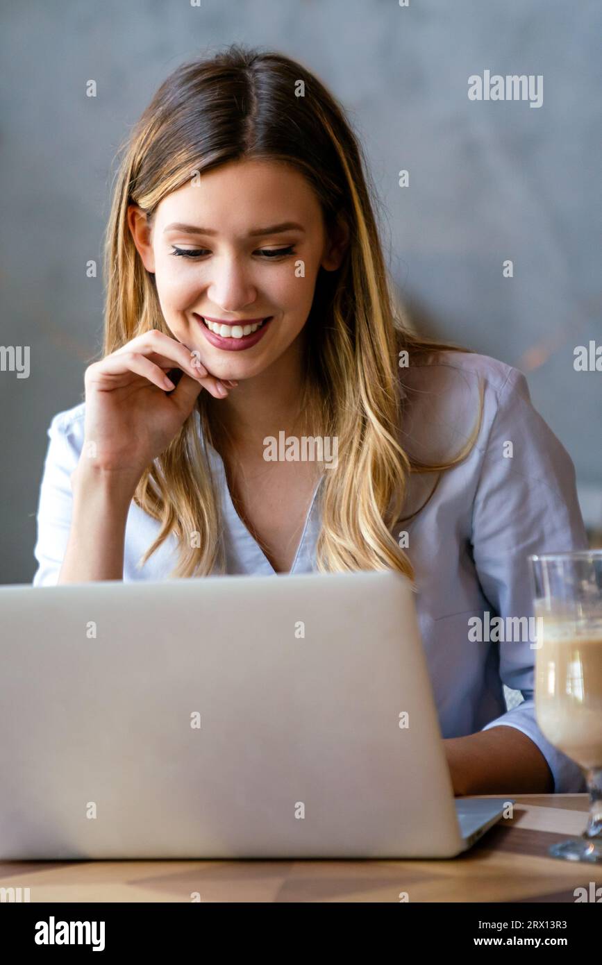 Portrait of beautiful business woman working on laptop. Business work online concept. Stock Photo