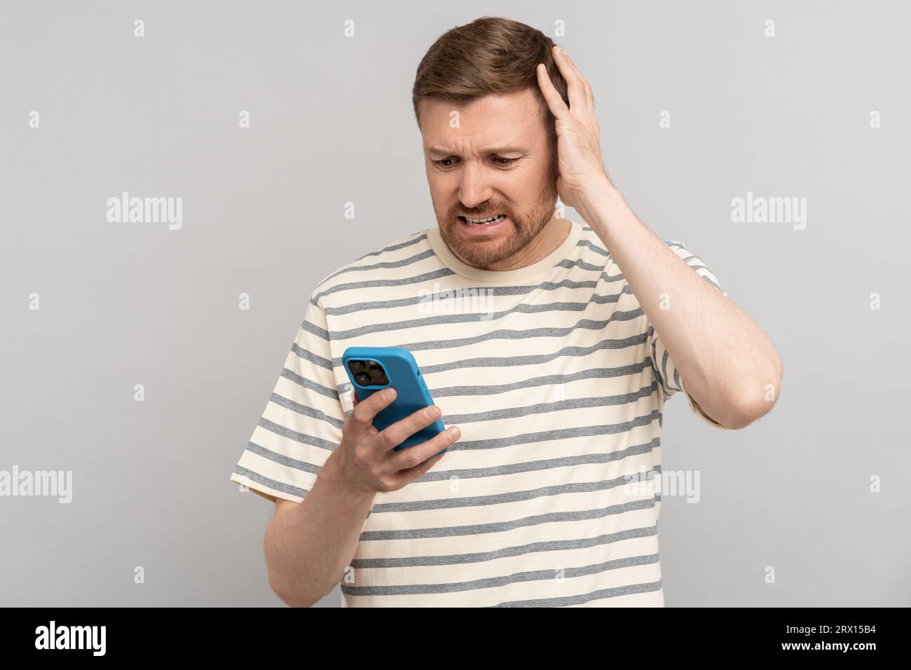Awkward man looking phone hi-res stock photography and images - Alamy