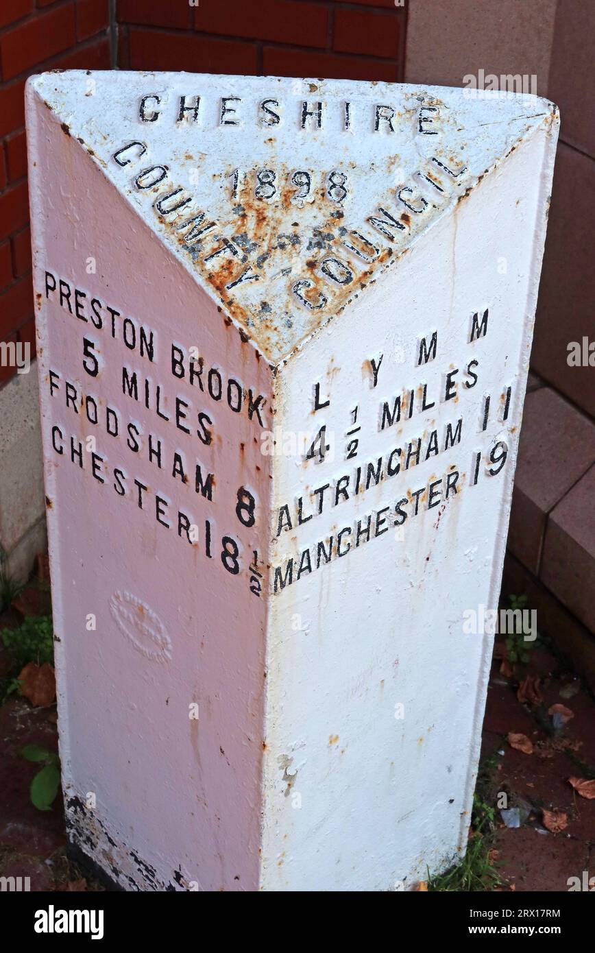 Cheshire County Council white metal mile post 1898 - to Lymm, Manchester, Altrincham, at Stockton Heath A49, A56 junction, Warrington, England, UK, Stock Photo