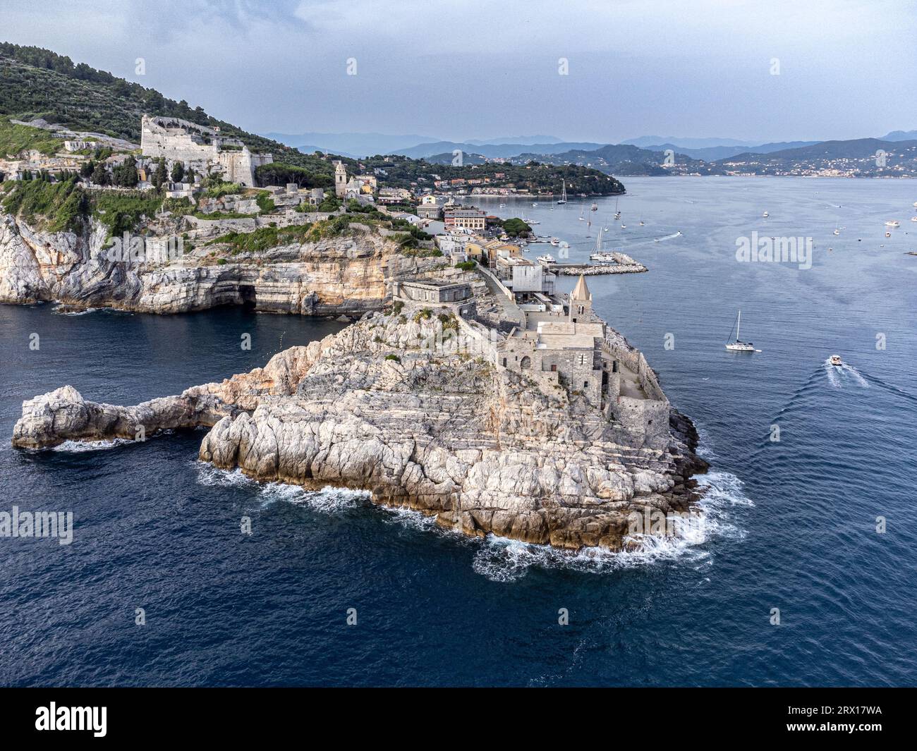 An aerial view of a small town situated on a body of water with ...