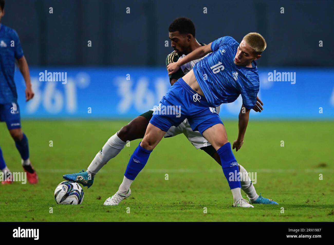 Hangzhou, China. 21st Sep, 2023. Buyannemekh Ganbat (front) of the Mongolia men football team and Mohammed E S Alyami (back) of the Saudi Arabia men football team seen in action during the 19th Asian Games 2023 Men's football group round Group B match between Saudi Arabia and Mongolia at Linping Sports Centre Stadium. Final score; Saudi Arabia 3:0 Mongolia. Credit: SOPA Images Limited/Alamy Live News Stock Photo