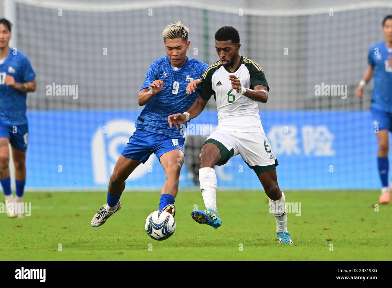 Hangzhou, China. 21st Sep, 2023. Naif Khalid R Masoud (R) of the Saudi Arabia men football team and Uuganbat Temulen (L) of the Mongolia men football team seen in action during the 19th Asian Games 2023 men's football group round Group B match between Saudi Arabia and Mongolia at Linping Sports Centre Stadium. Final score; Saudi Arabia 3:0 Mongolia. Credit: SOPA Images Limited/Alamy Live News Stock Photo