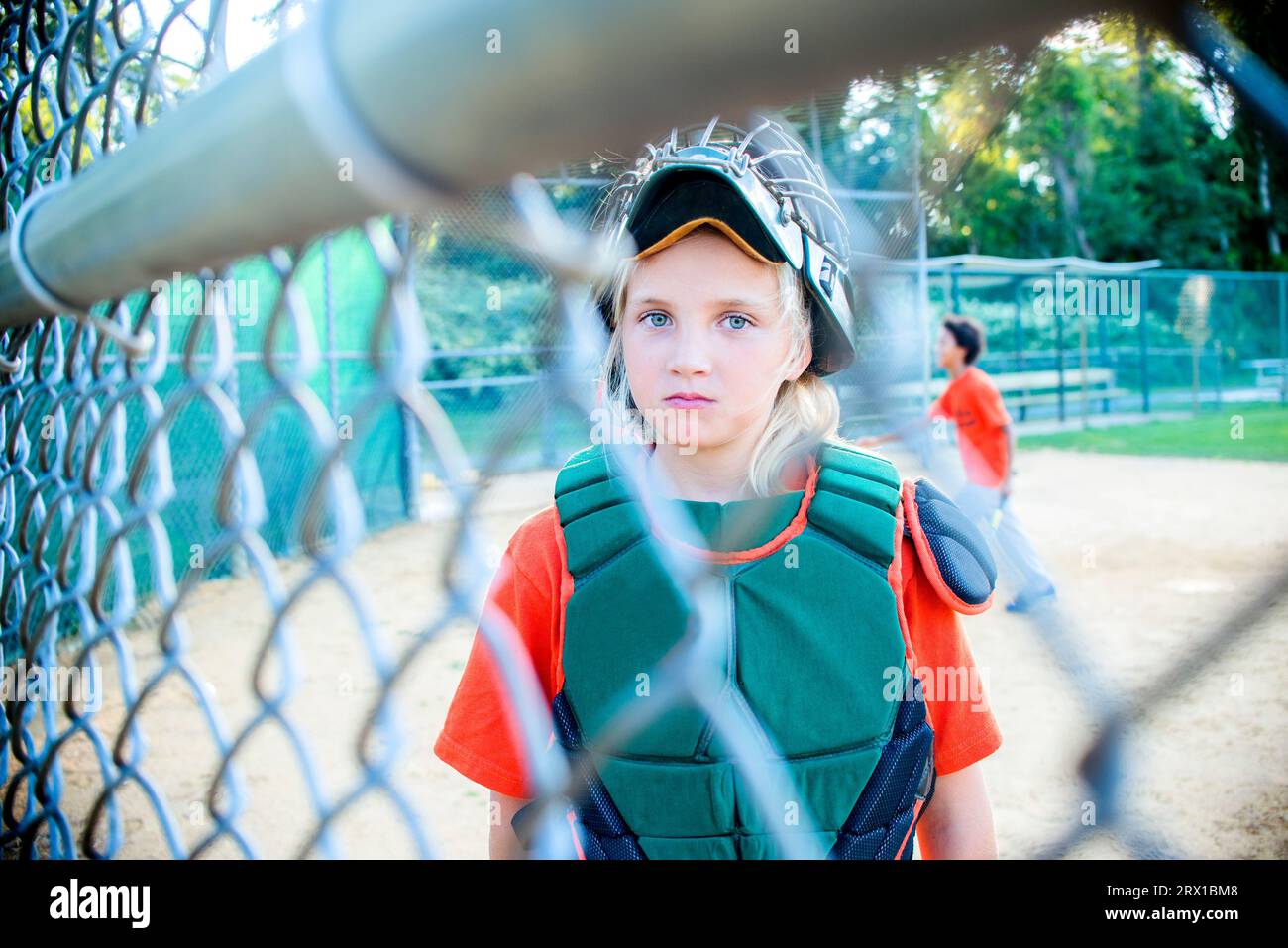 A  portrait of a 10 year old  girl who is the catcher on the team Stock Photo