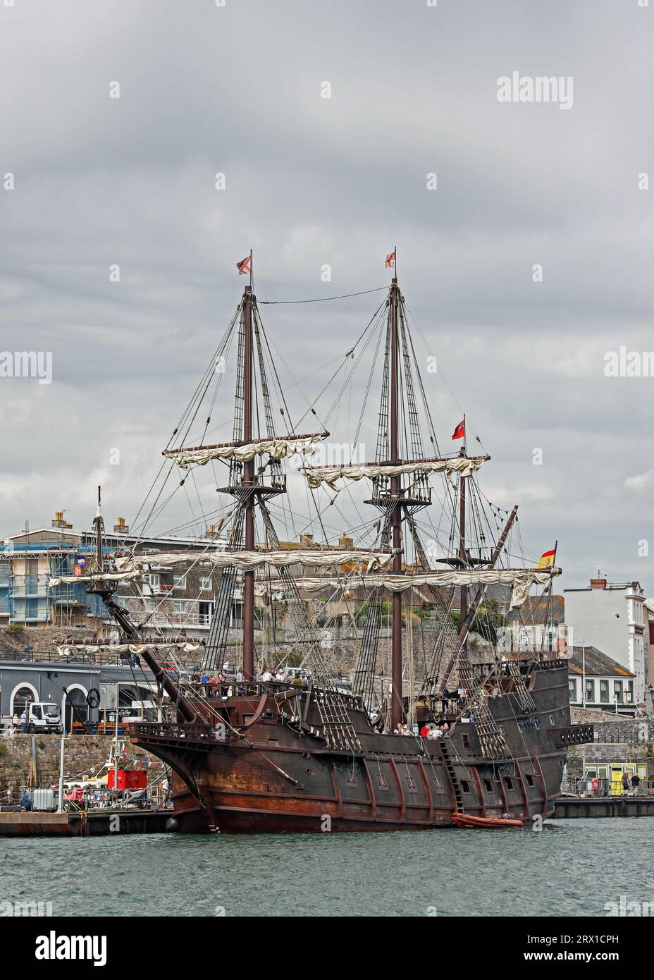 Upright image of Visitors explore the decks of the El Galeon berthed at the Barbican Pontoon in Plymouth. The full size replica of a 17th century Span Stock Photo