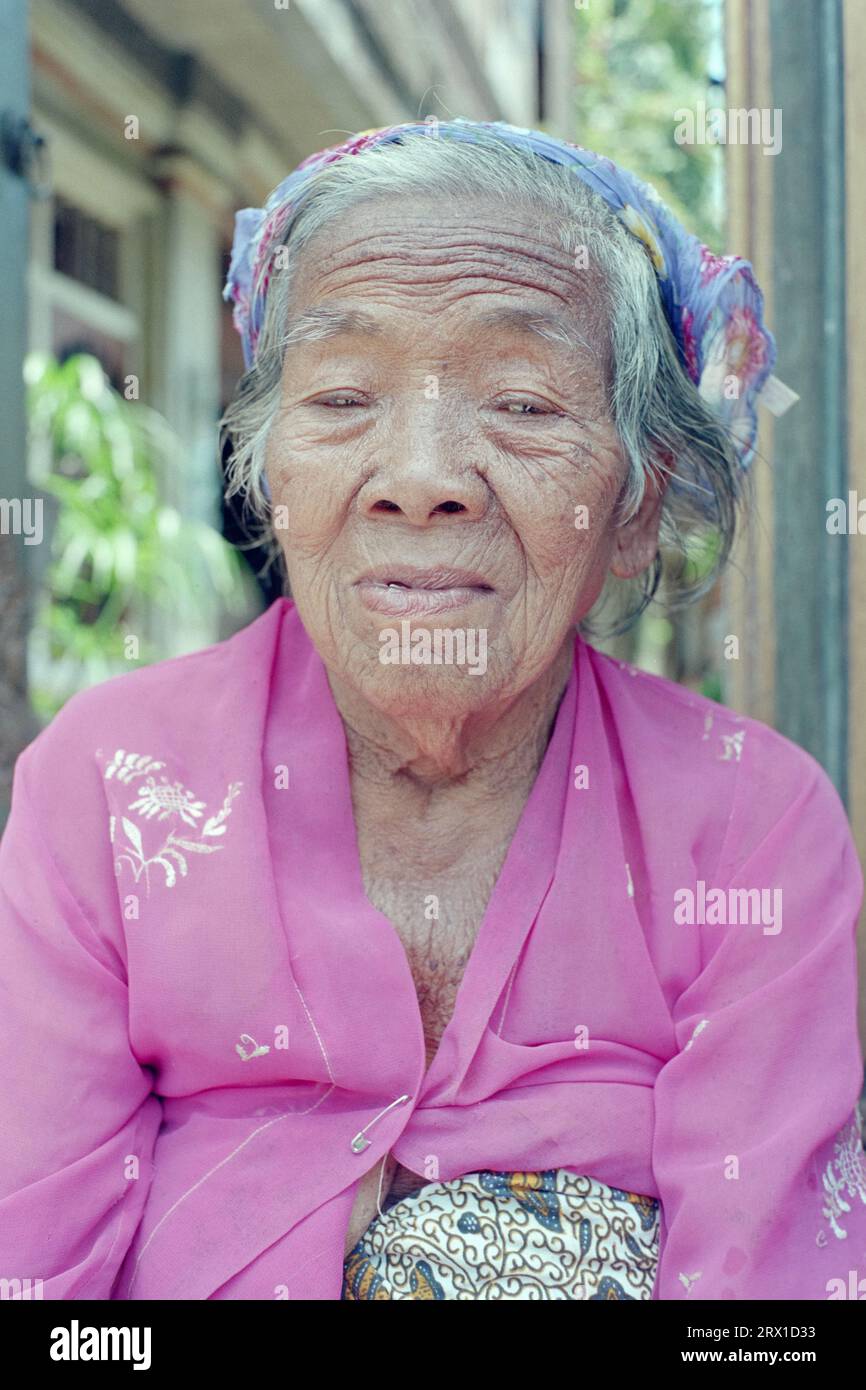 Portrait of an elderly Balinese woman outside her porch Stock Photo