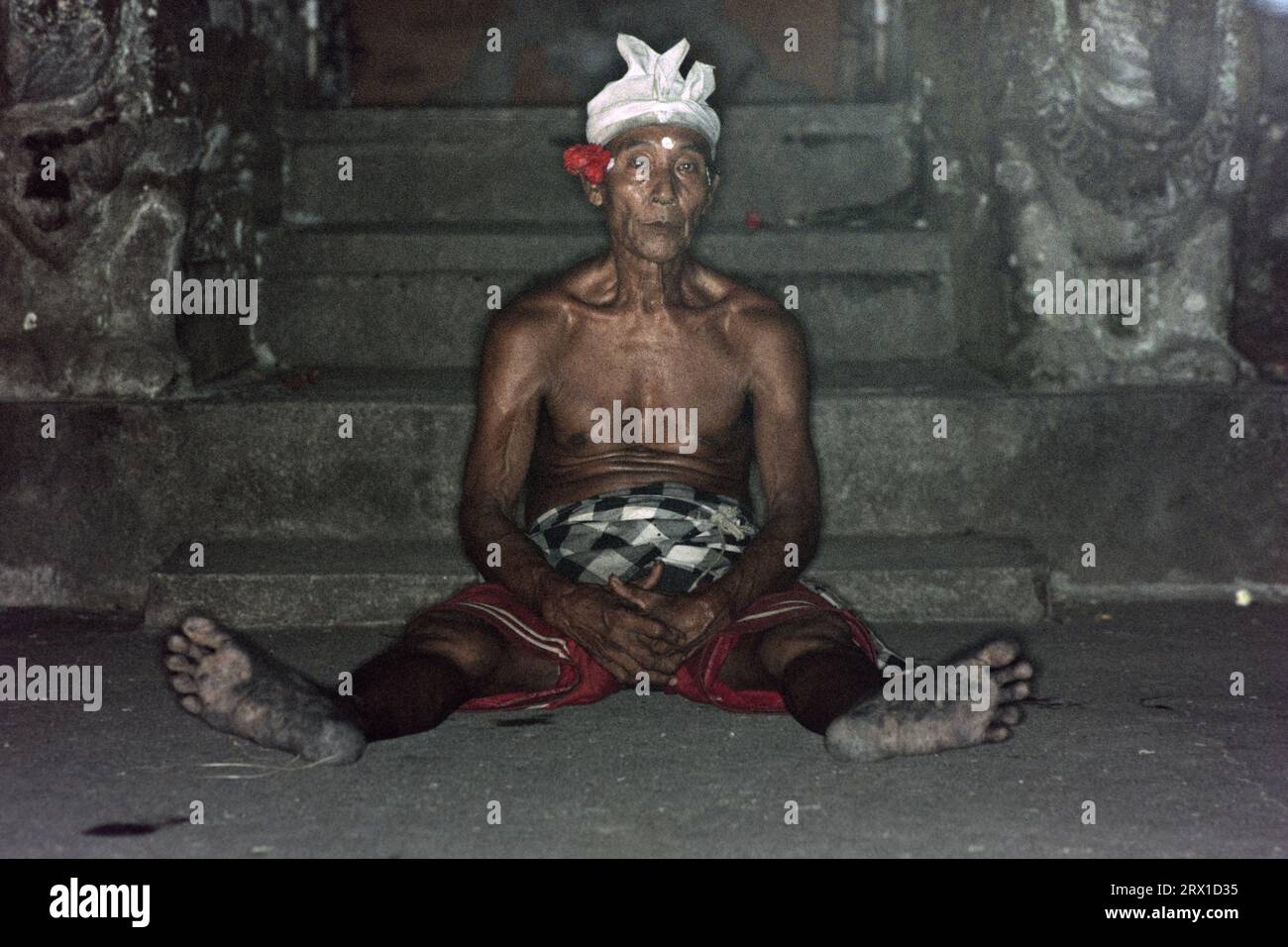 Portrait of elderly Balinese man exhausted after fire ceremony Stock Photo