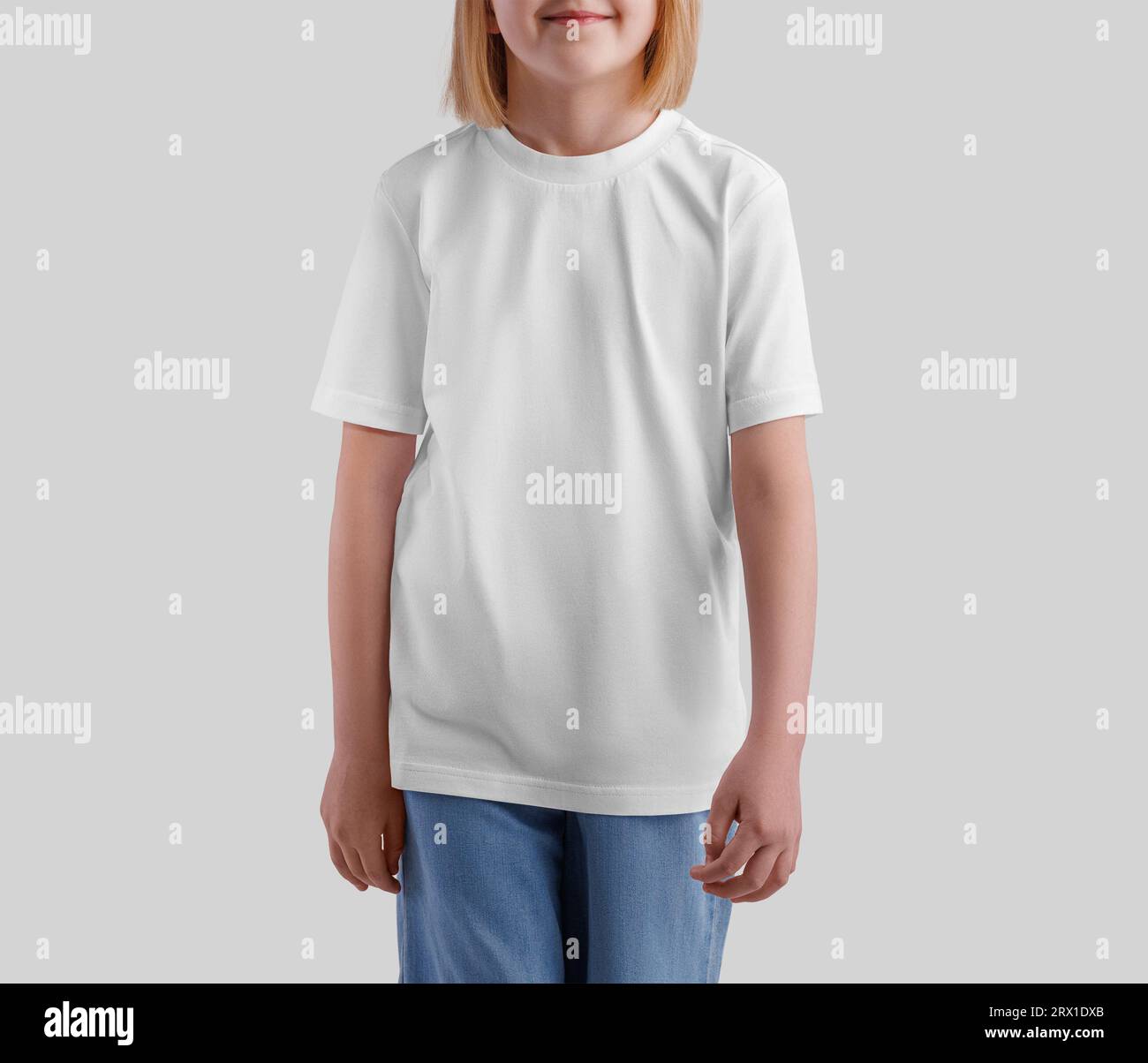 White t-shirt template on a posing child, for design, print, pattern, advertising, front view. Product photography. Mockup of casual kid's shirt isola Stock Photo