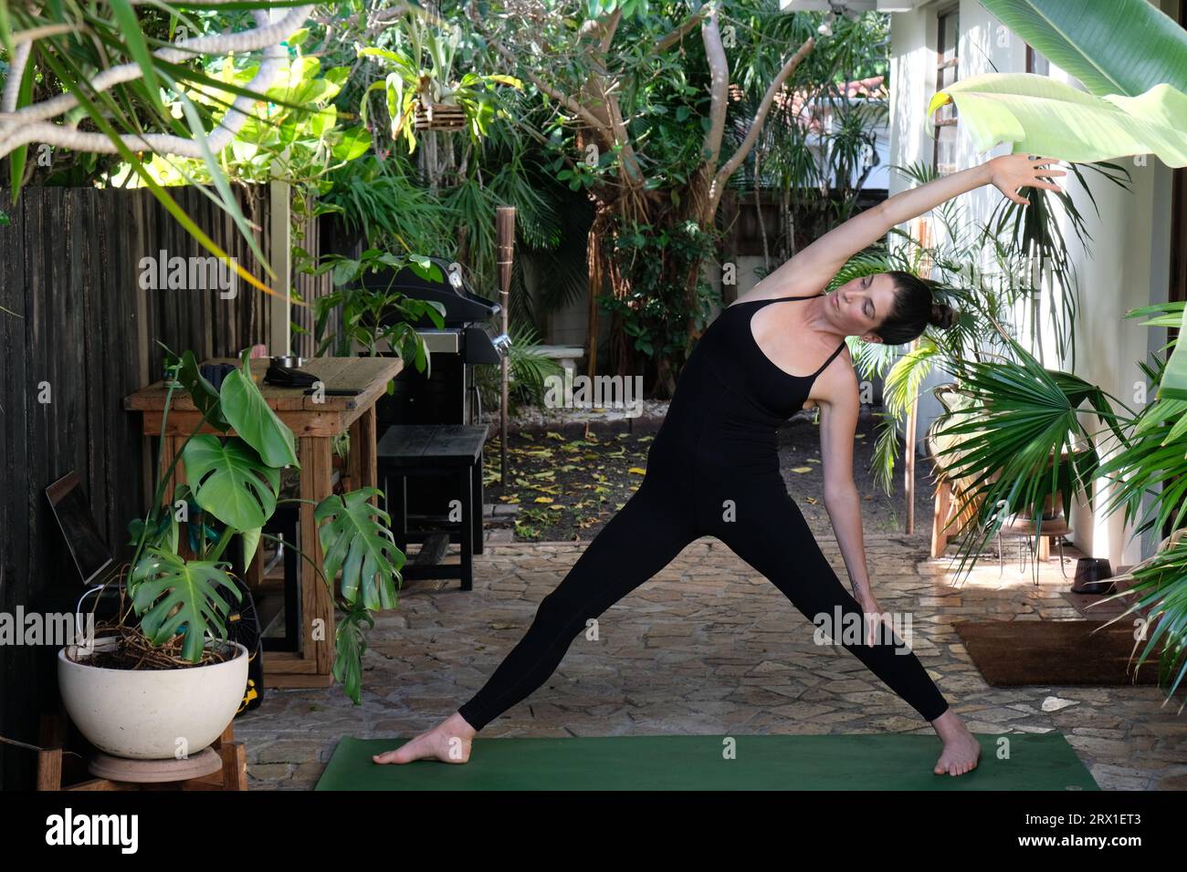 Young Woman Practicing Yoga outside Stock Photo