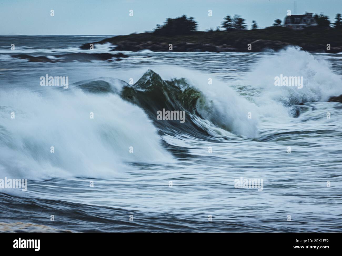 large atlantic ocean wave breaks along the Maine coast during storm Stock Photo