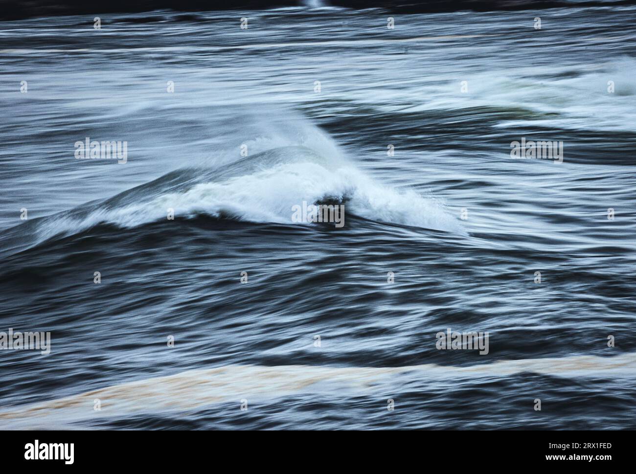 rough atlantic ocean wave breaks along the Maine coast Stock Photo