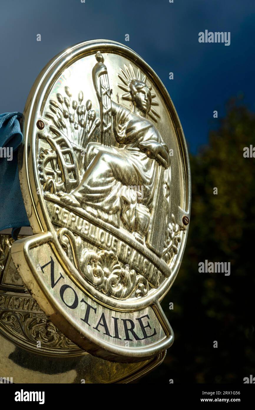 Golden Sign for a French Notary on a Sunny Day Stock Photo