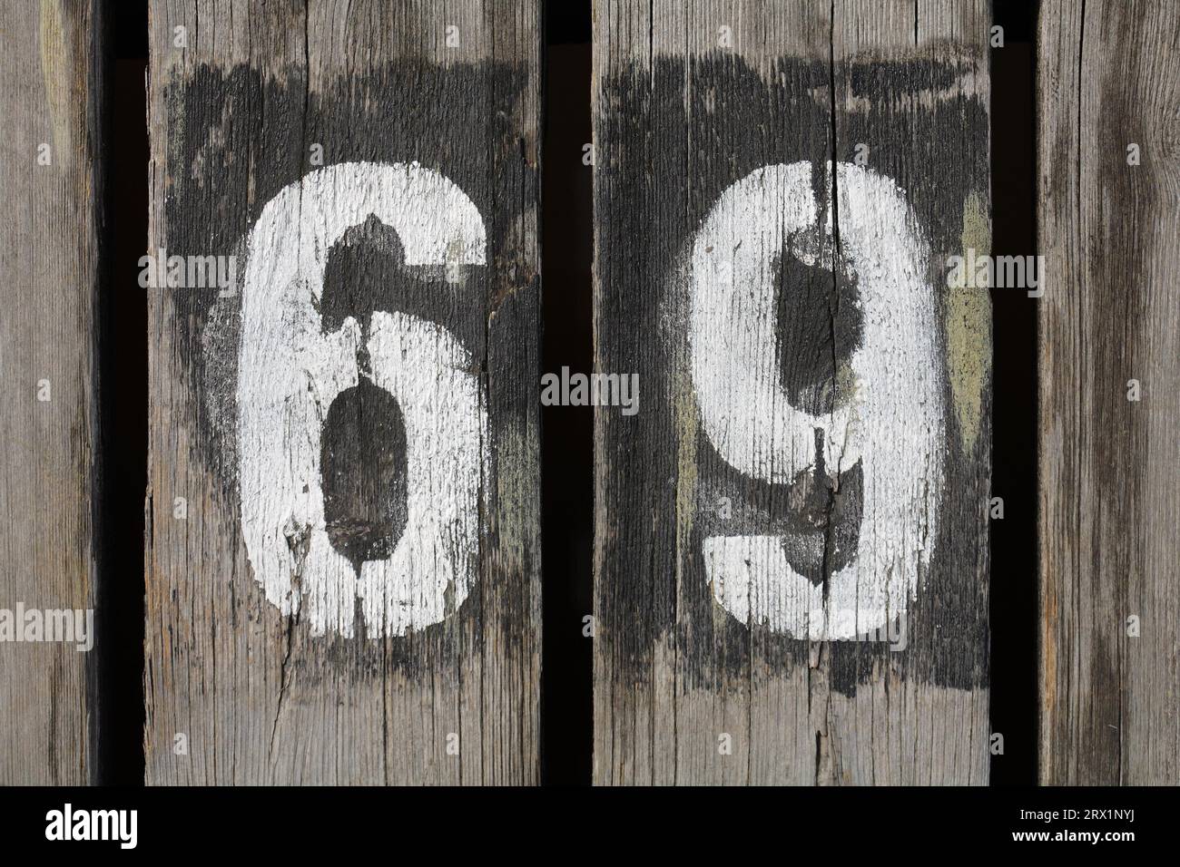 Gunge painted number 69 on wood Stock Photo