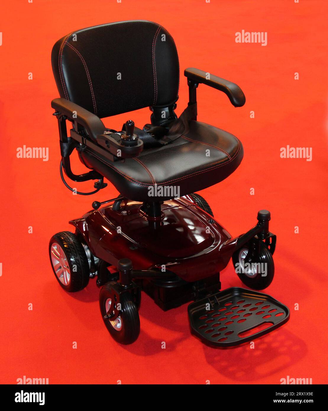 A Compact Four Wheeled Electric Disability Wheelchair. Stock Photo