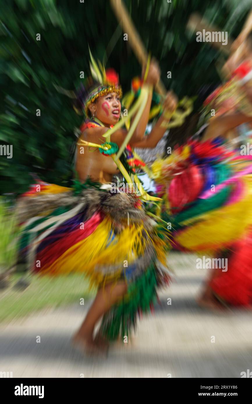 Dancer from Yap Island in traditional historical dress with headdress performs ritual bamboo dance with bamboo stick, Yap Island, Yap State, Caroline Stock Photo