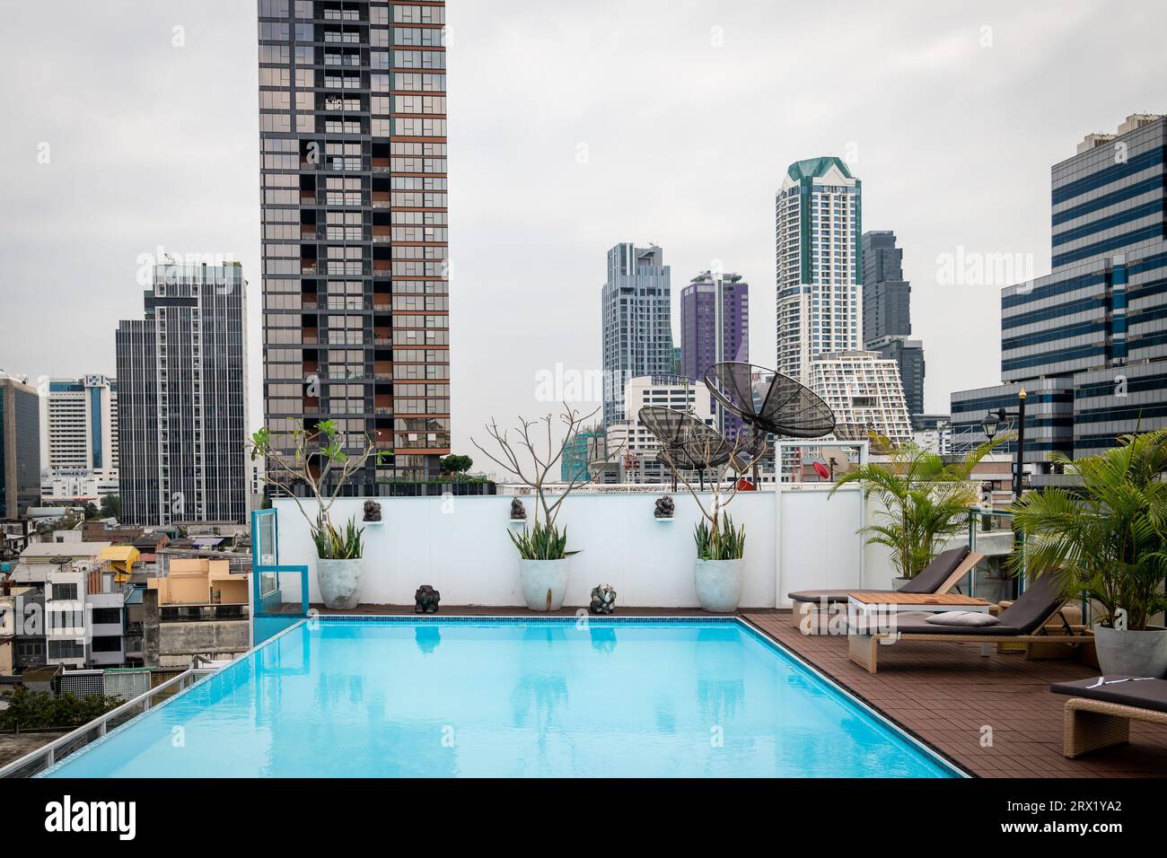 The view of buildings and skyline in the Silom area across the pool of Sapphire Hotel, Bangkok