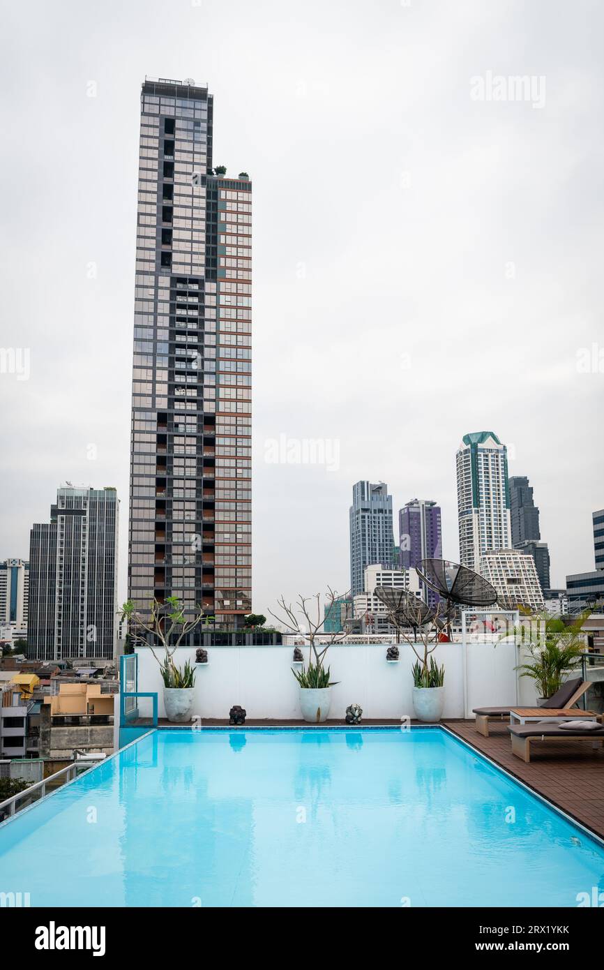 The view of buildings and skyline in the Silom area across the pool of Sapphire Hotel, Bangkok