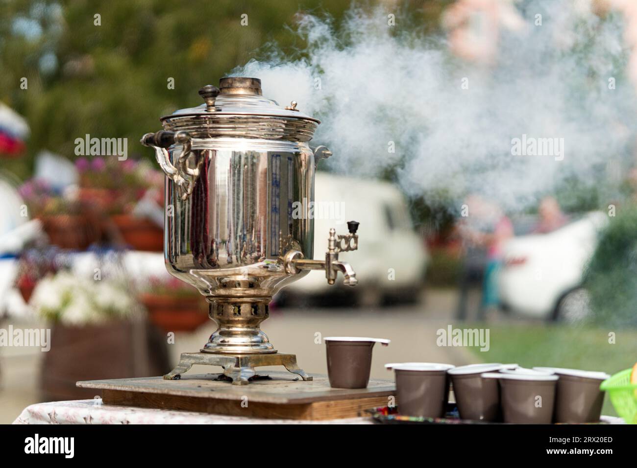 wood burning samovar in nature with smoke. traditional village tea drinking in ancient Russia. Stock Photo