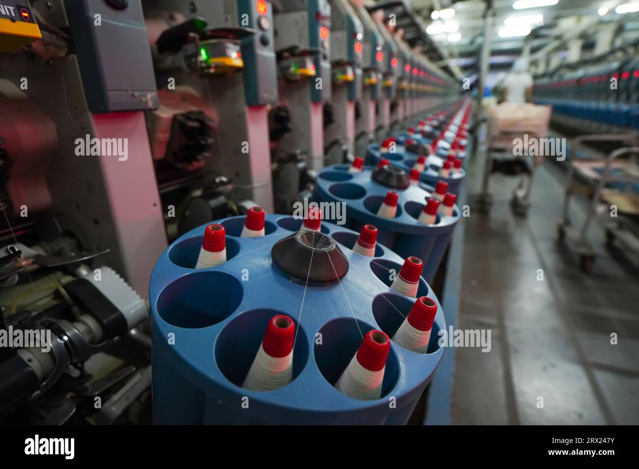 Workers are working nervously in a winding workshop in a spinning factory. Stock Photo