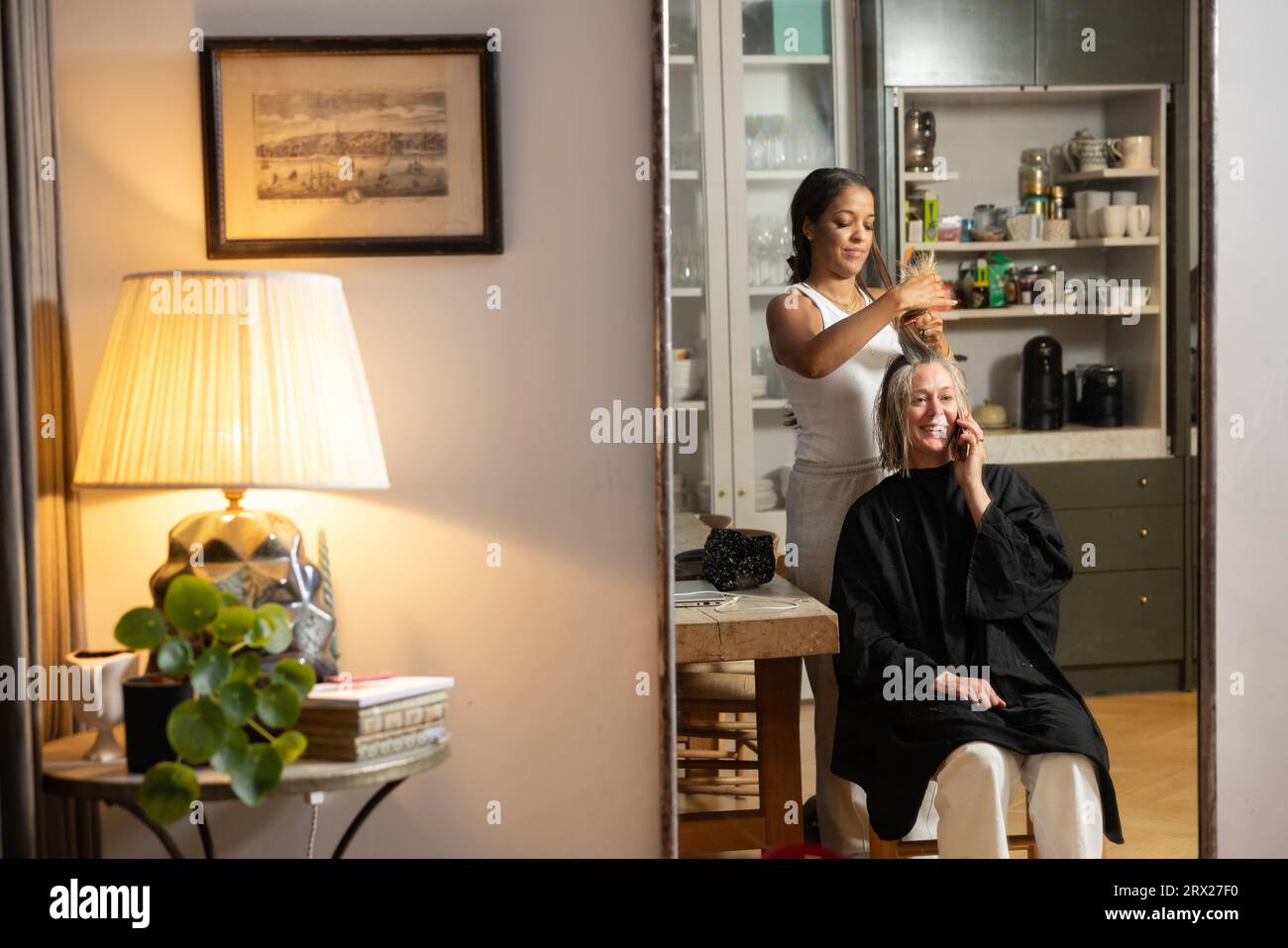 Home visiting hairdresser, a woman has a hairdressing appointment at