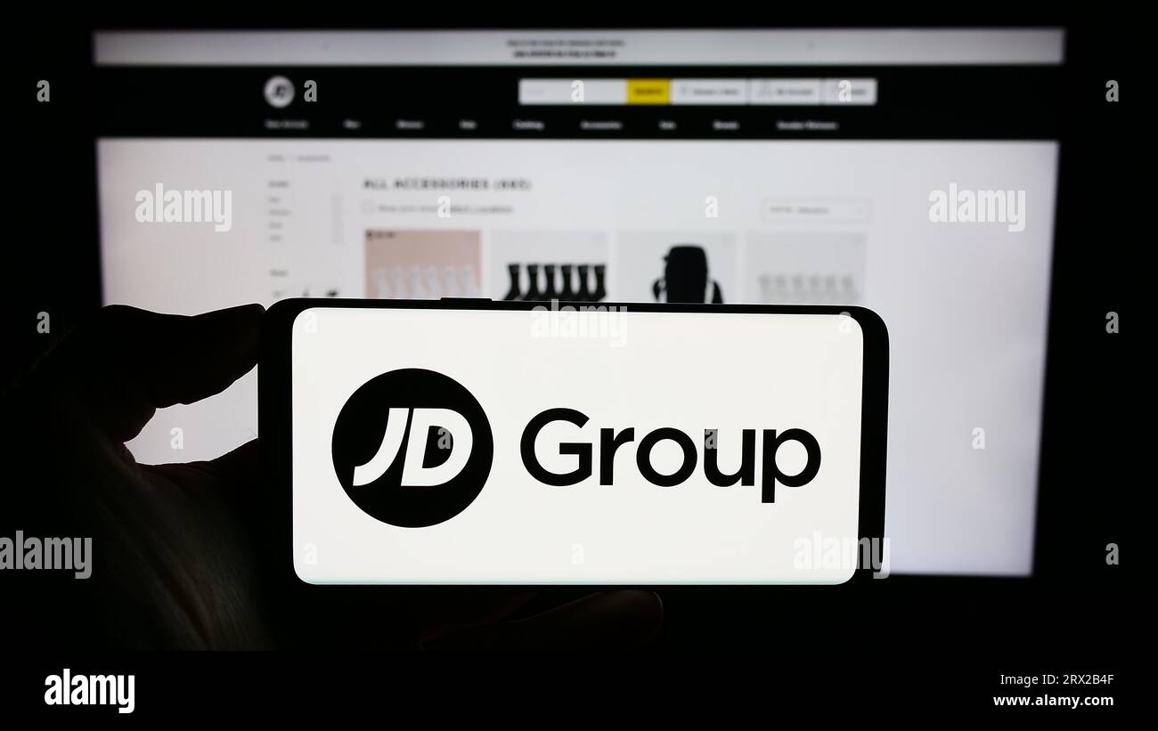 Person holding cellphone with logo of British retail company JD Sports
