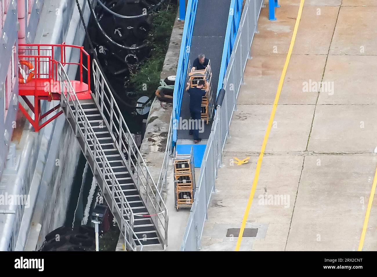 Portland, Dorset, UK. 22nd September 2023. Workers with trollies removing stacks of chairs from