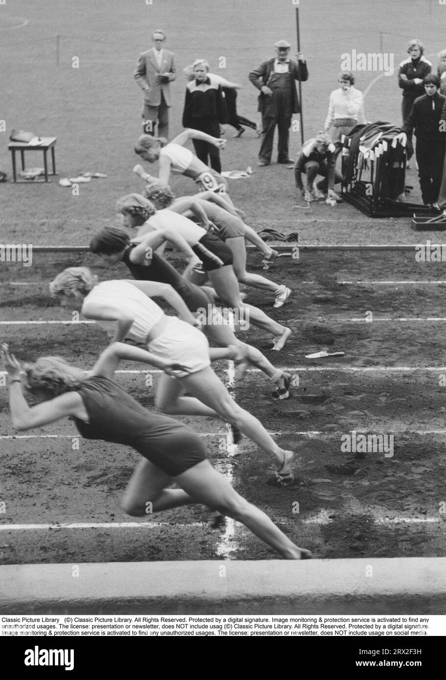 The start of a running competition. Six competing women are seen right at the starting moment, taking the first powerful steps in the 100-meter race. Sweden 1957 Stock Photo