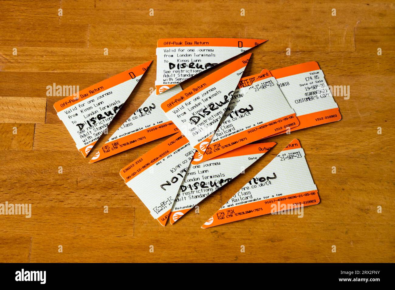 Train tickets cut in half ready to claim refund from Great Northern following train cancellation due to service disruption. Stock Photo