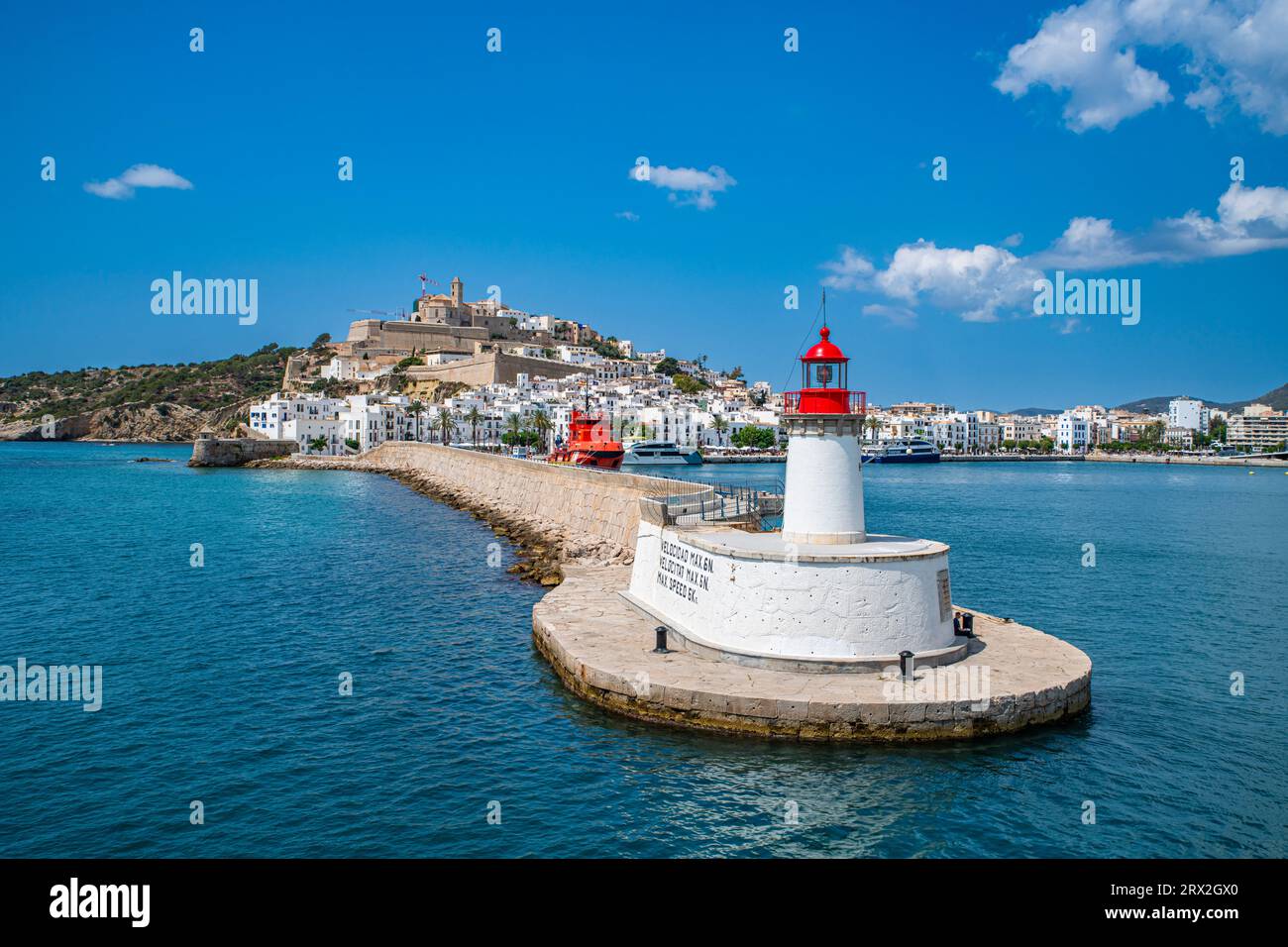 Harbour Lighthouse And The Old Town Of Ibiza With Its Castle Seen.