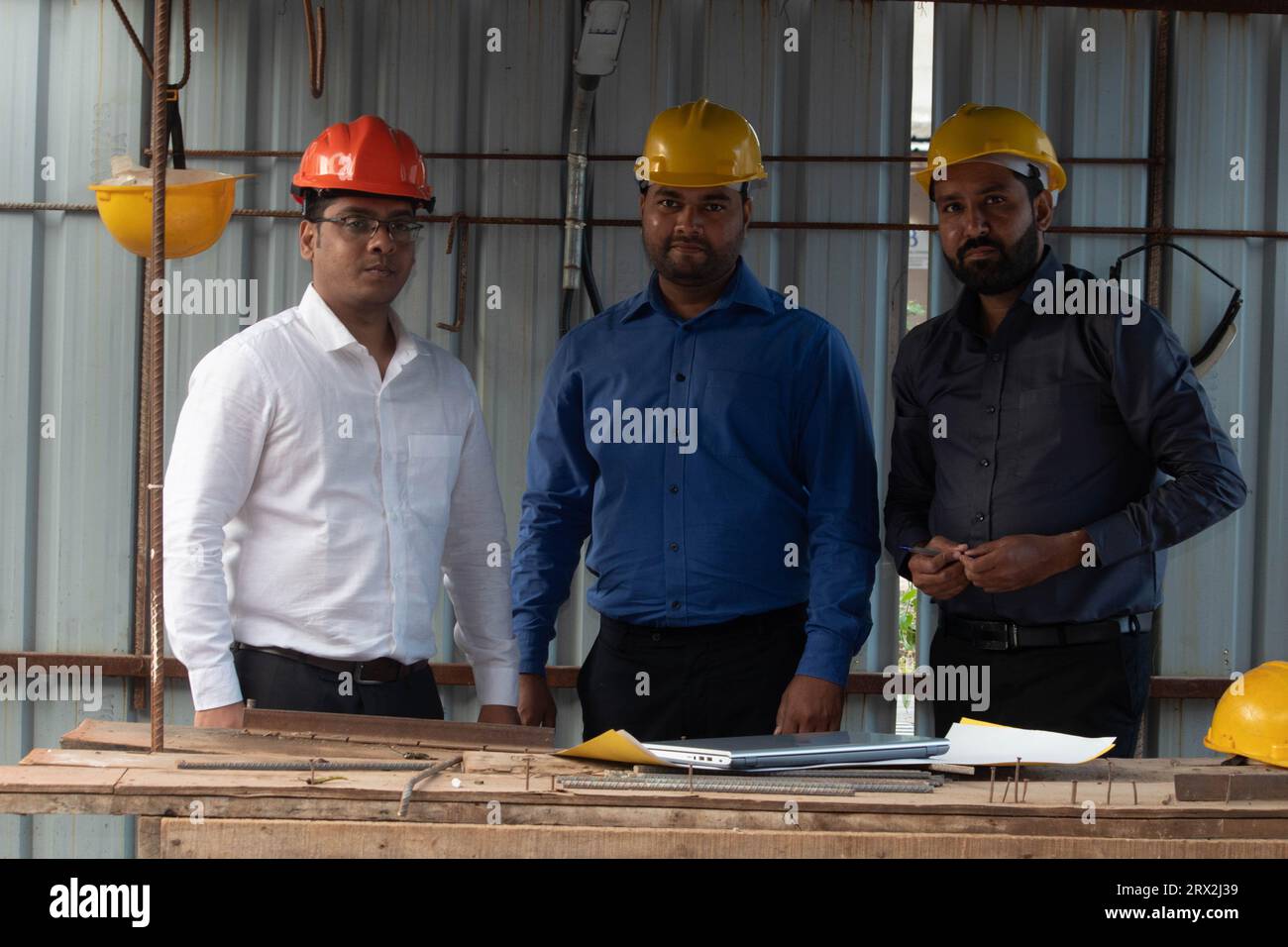 Premium Photo  Three men wearing hard hats are talking to a man in a hard  hat