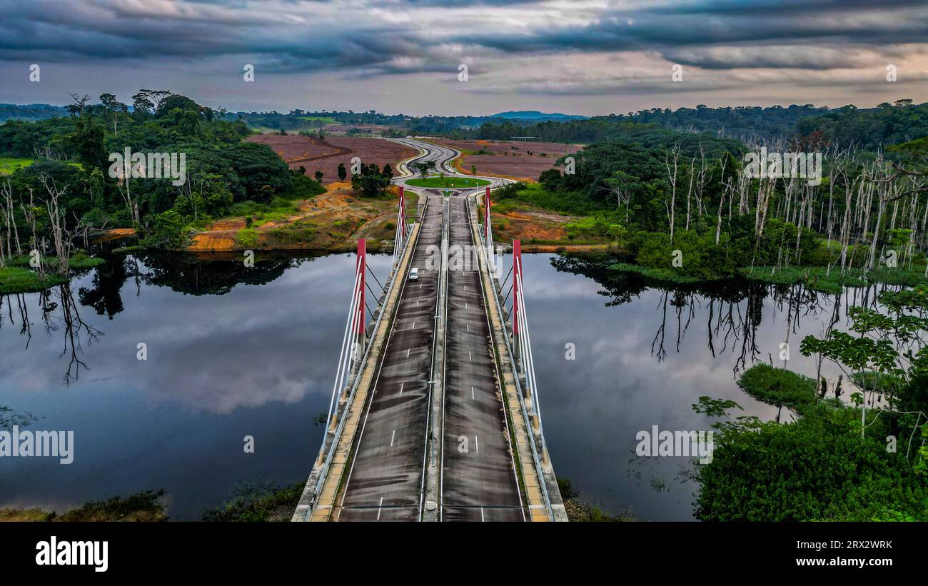 Aerial of a bridge cutting through the jungle to the future capital Ciudad de la Paz, Rio Muni, Equatorial Guinea, Africa Stock Photo