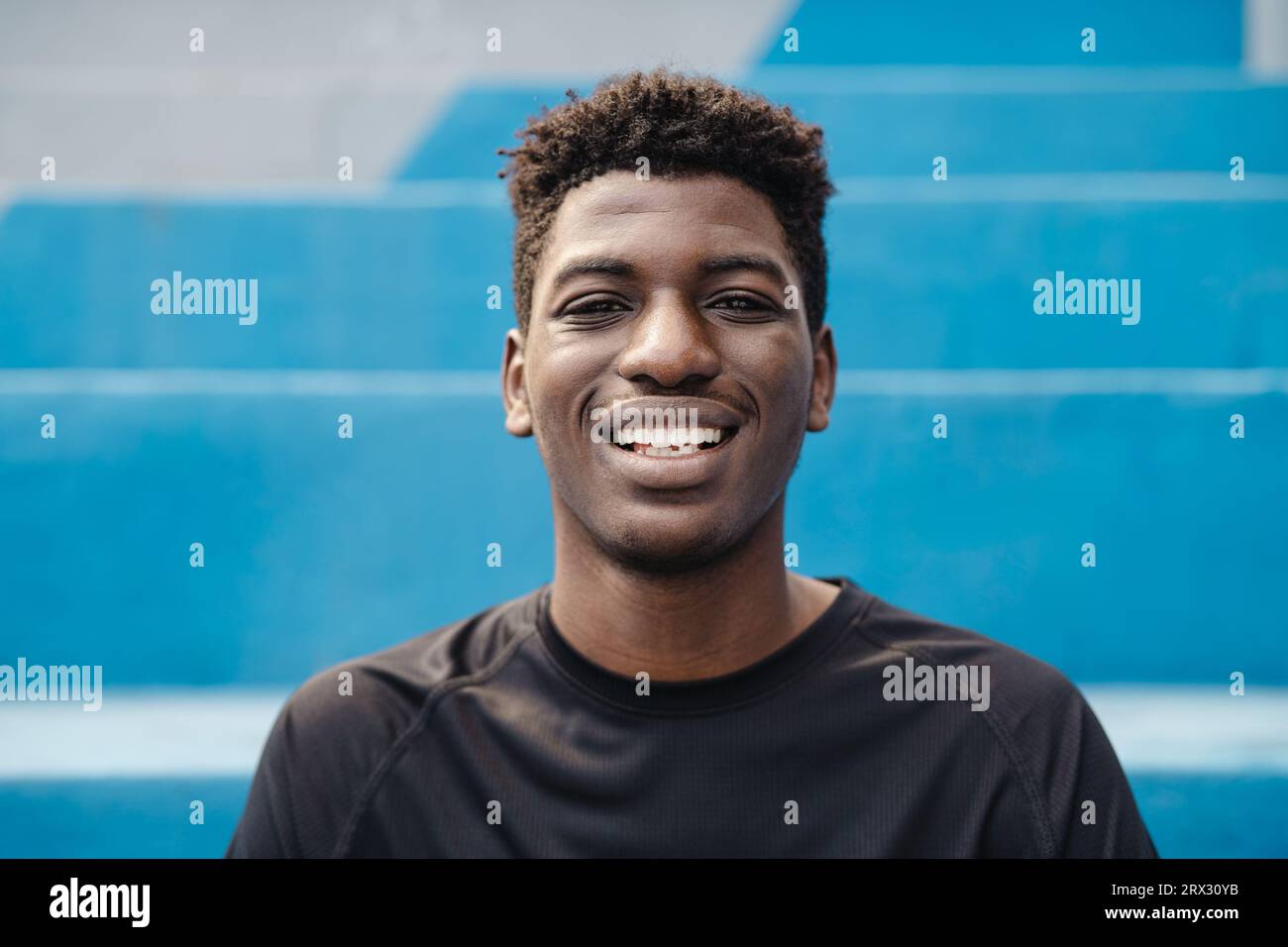 Happy young African teenager smiling in front of camera Stock Photo