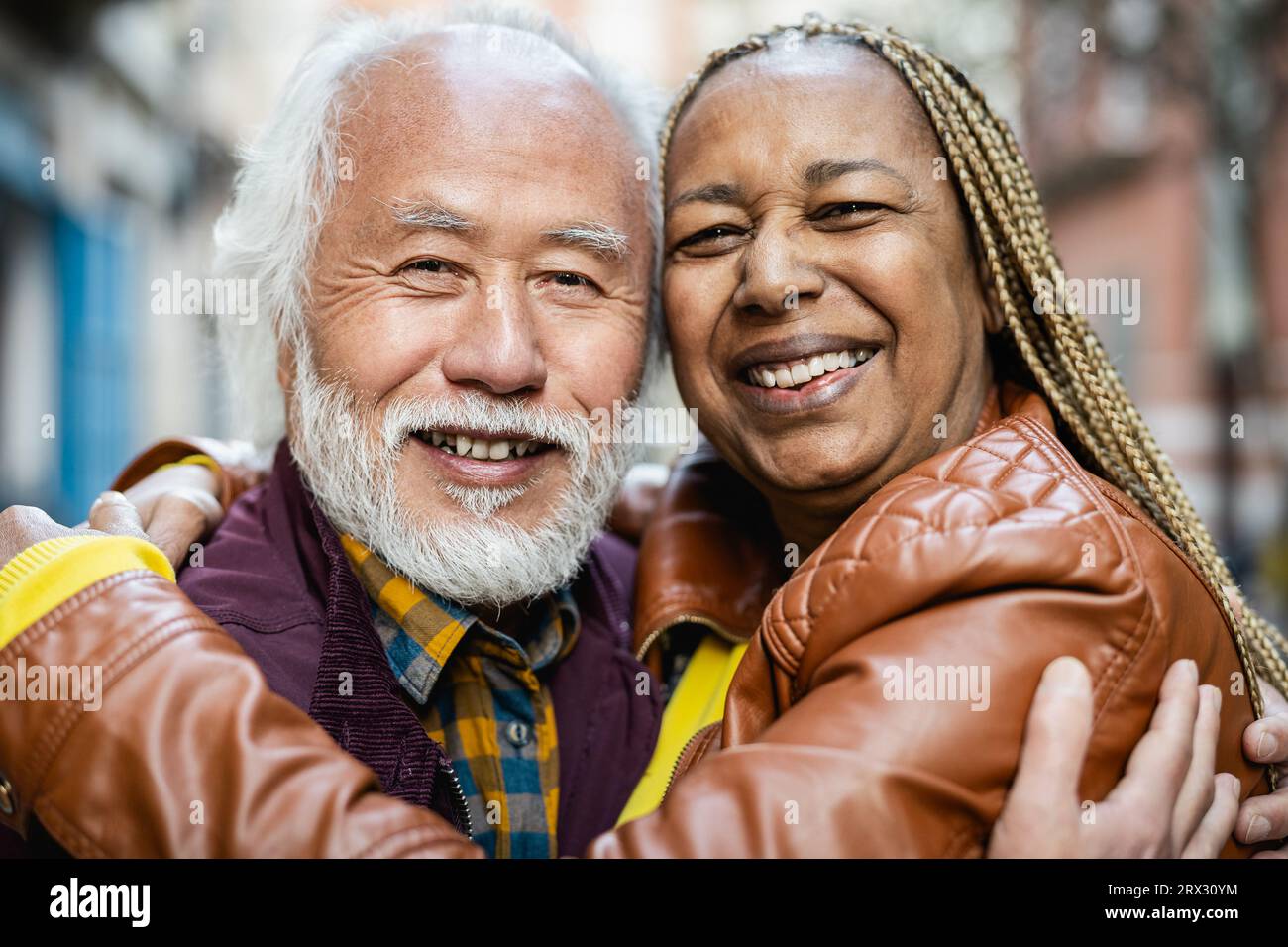 Happy multiracial senior couple portrait - Elderly people lifestyle and love relationship concept Stock Photo