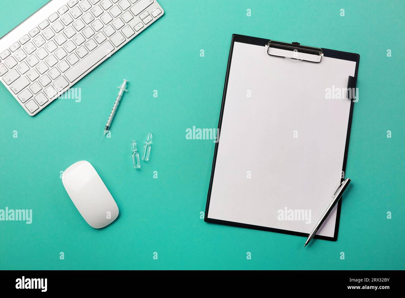 Doctors desk with tablet, pen, keyboard, syringe and ampoules. Top view with place for your text