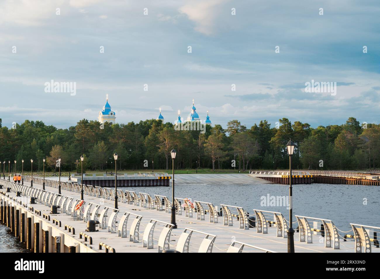 View from Lake Ladoga on the pier of Konevets Island. In the distance are the domes of the Konevets Nativity of the Virgin Mother of God Monastery. Stock Photo