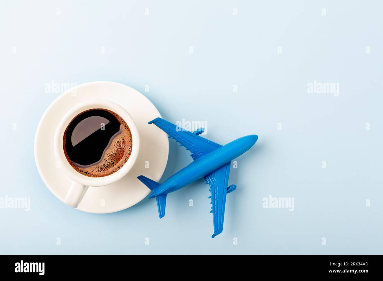 coffee with airplane model on blue background. Stock Photo