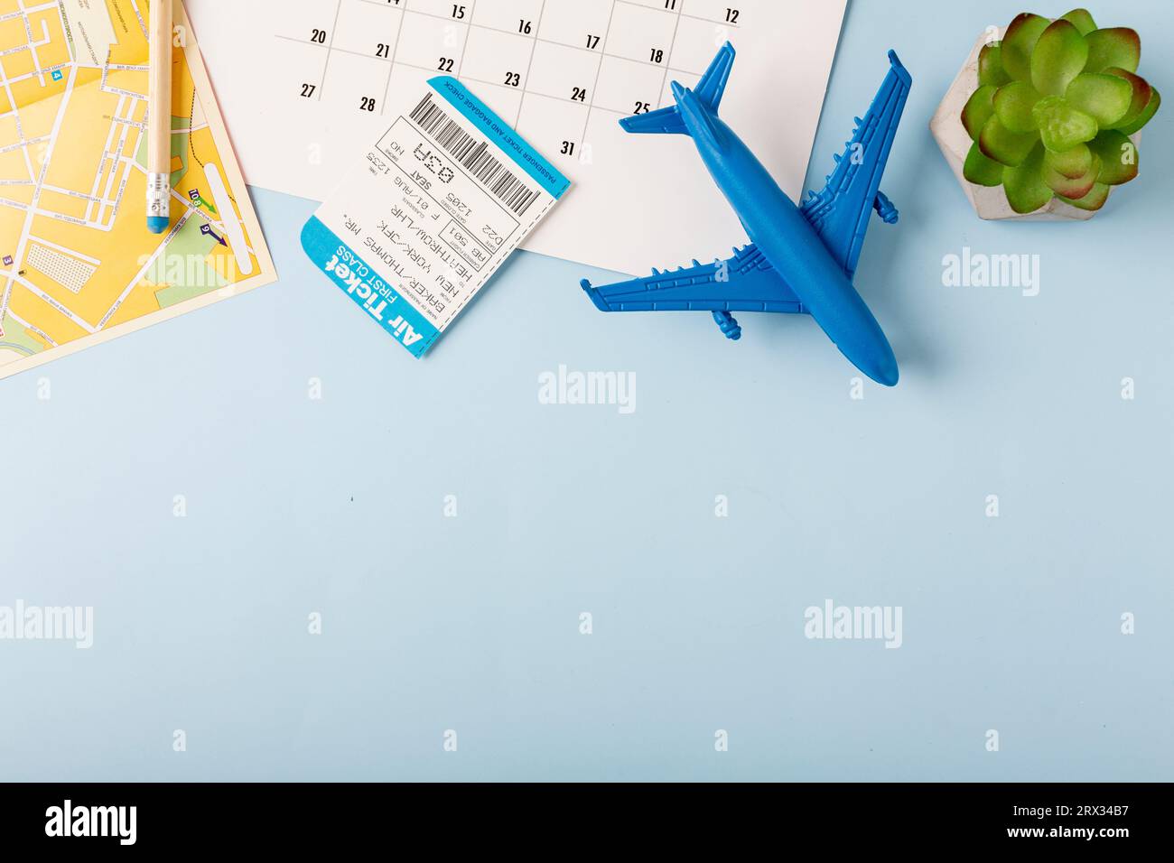 Desktop with a map, coffee and an airplane, on a blue background. Travel concept. High quality photo Stock Photo