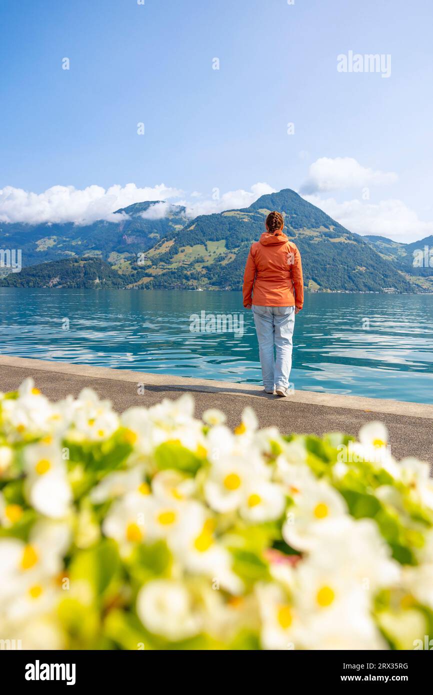 A tourist admires the beautiful Lake of the Four Cantons on a sunny day, Beckenried, Canton of Nidvaldo, Switzerland, Europe Stock Photo